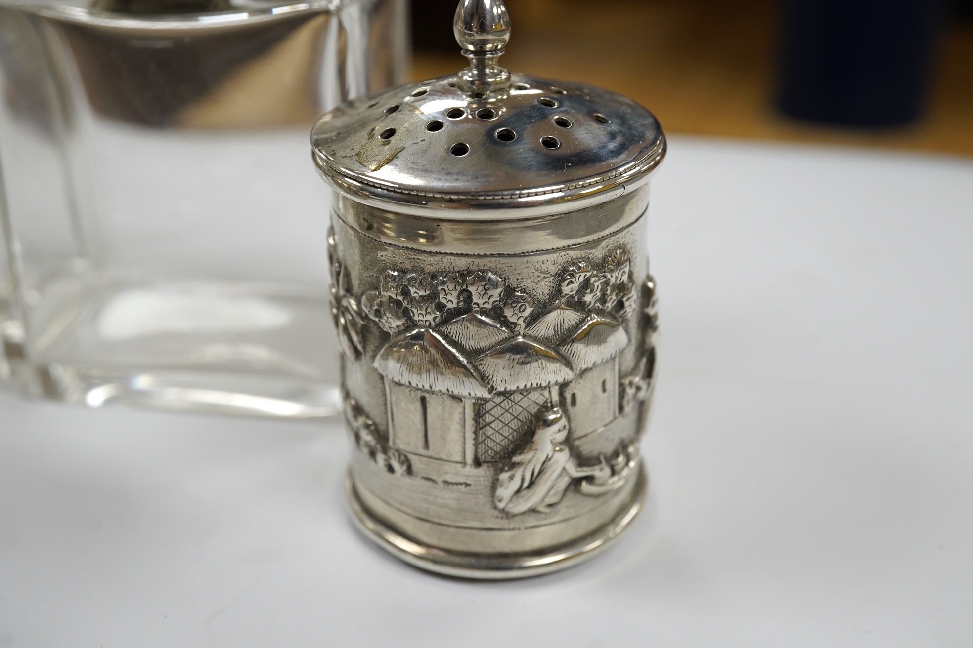 Small silver including a napkin ring, hand mirror and two mounted glass toilet jars, together with three Indian white metal condiments and a French white metal wine taster. Condition - poor to fair
